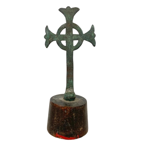 20b - A 19th century bronze Celtic cross on wooden base. 21.5cm.