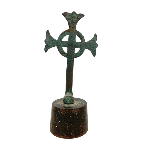 20b - A 19th century bronze Celtic cross on wooden base. 21.5cm.