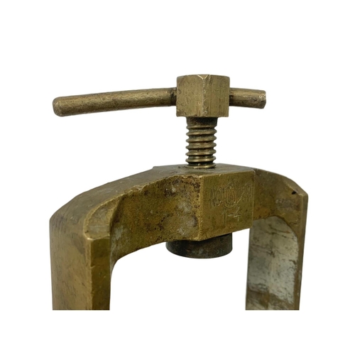 324a - An early 20th century bronze dental press. 11 x 15cm.