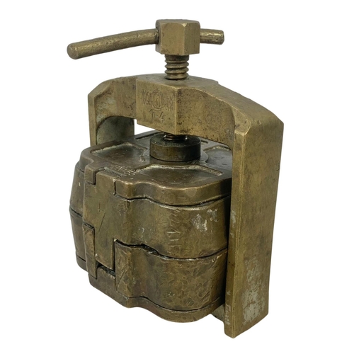 324a - An early 20th century bronze dental press. 11 x 15cm.