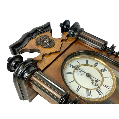 324k - A large Victorian walnut Vienna wall clock. With weight, pendulum and key. 116cm