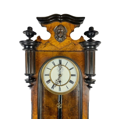 324k - A large Victorian walnut Vienna wall clock. With weight, pendulum and key. 116cm