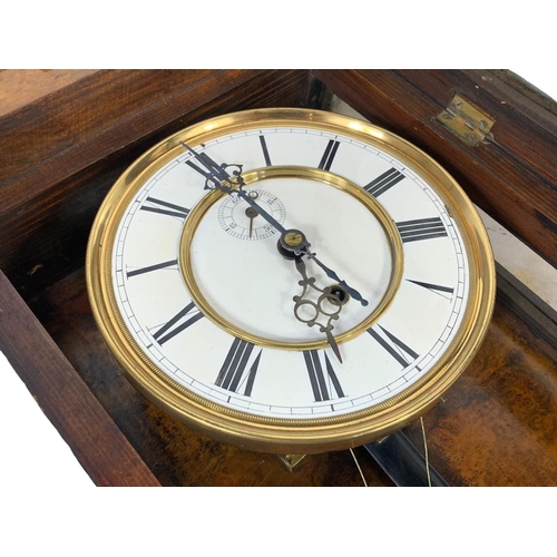 324k - A large Victorian walnut Vienna wall clock. With weight, pendulum and key. 116cm