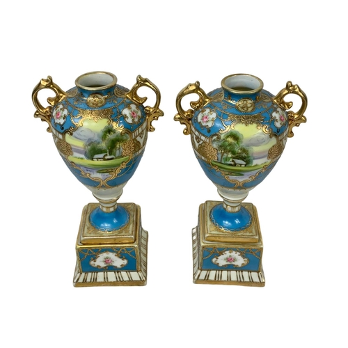 501g - A pair of early 20th century Noritake hand painted gilt porcelain urns. Circa 1908. 19cm.