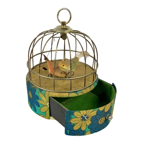 715 - A vintage windup music jewellery box with swinging bird. 16 x 21cm.