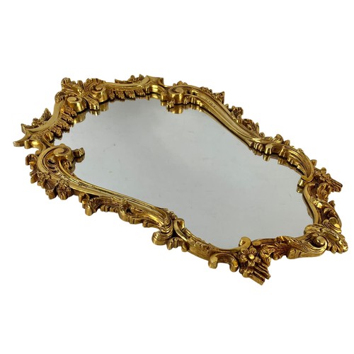 160I - An ornate gilt framed mirror. 49 x 74cm