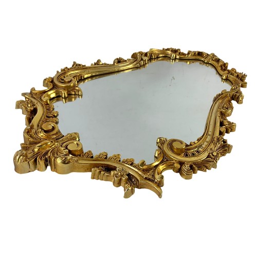 160I - An ornate gilt framed mirror. 49 x 74cm