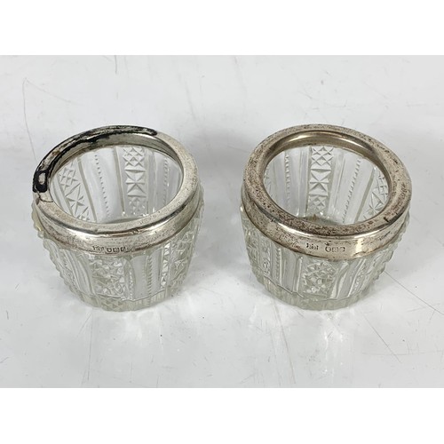 689 - A pair of early 20th century London silver rimmed salt bowls in cut glass. 5.5 x 5cm