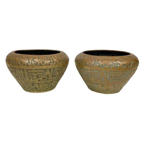 42b - A pair of large mid 19th century Persian brass planters with decoration describing the “Middle Easte... 