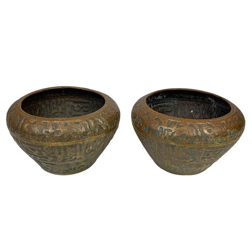 42b - A pair of large mid 19th century Persian brass planters with decoration describing the “Middle Easte... 