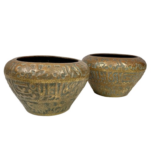 114 - A pair of large mid 19th century Persian brass planters with decoration describing the “Middle Easte... 