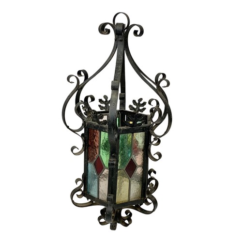 120 - A vintage wrought iron light fitting with stain glass. 29 x 60cm.
