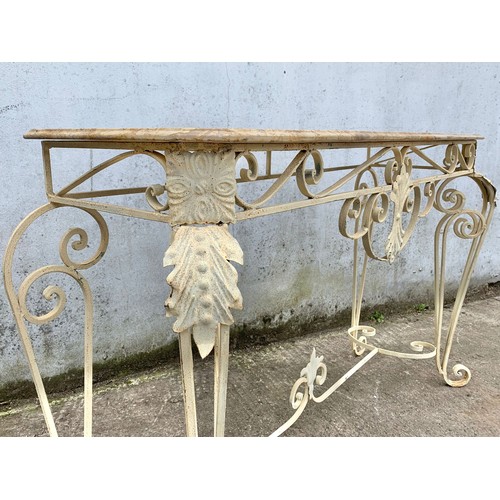 1026 - A large vintage ornate marble top console table on an wrought iron base. 142 x 46 x 90cm