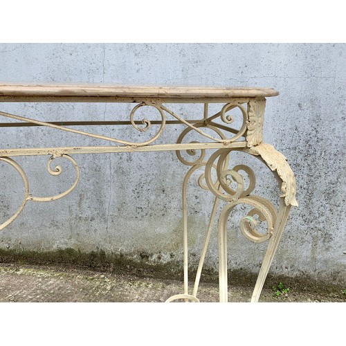 1026 - A large vintage ornate marble top console table on an wrought iron base. 142 x 46 x 90cm