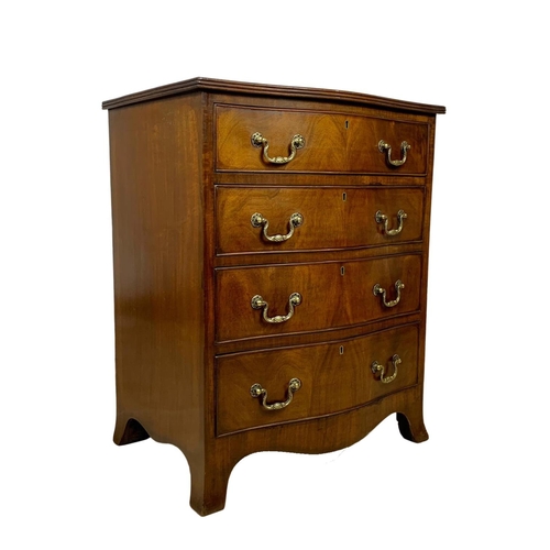 966 - An early 20th century Georgian style mahogany serpentine chest of drawers with brass drop handles. 6... 