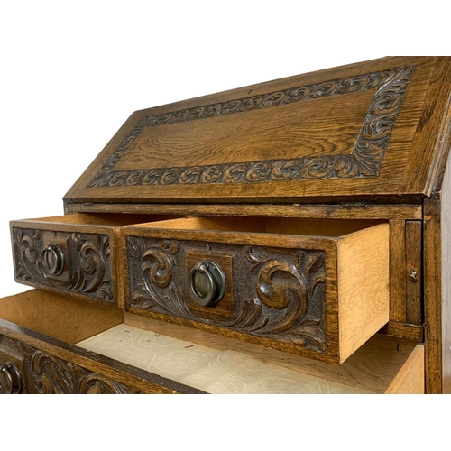 998 - Late 19th century carved oak writing bureau with 4 drawers and copper Art Nouveau handles. Circa 189... 