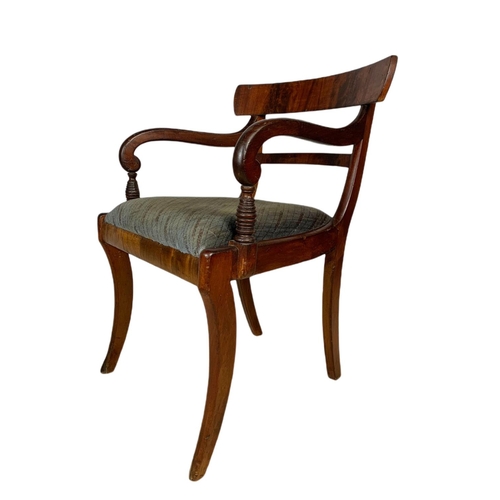 982 - Early 19th century Regency mahogany armchair with sabre legs.