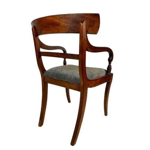 982 - Early 19th century Regency mahogany armchair with sabre legs.