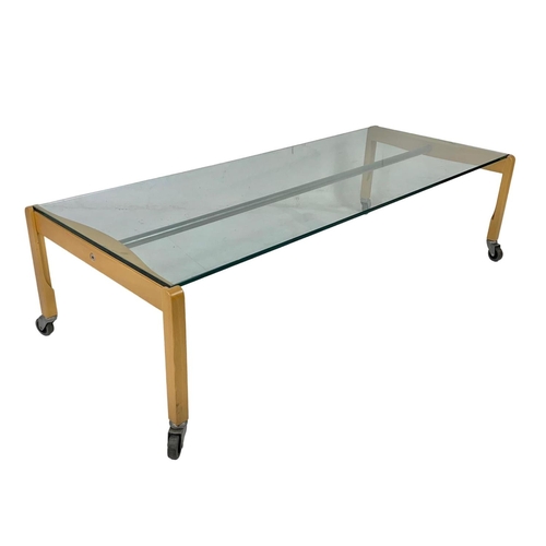 993 - Italian designer glass top coffee table by Zanotta. Circa 1980. 129 x 54 x 36.