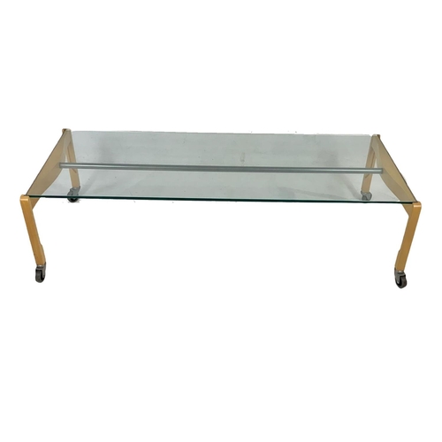 993 - Italian designer glass top coffee table by Zanotta. Circa 1980. 129 x 54 x 36.