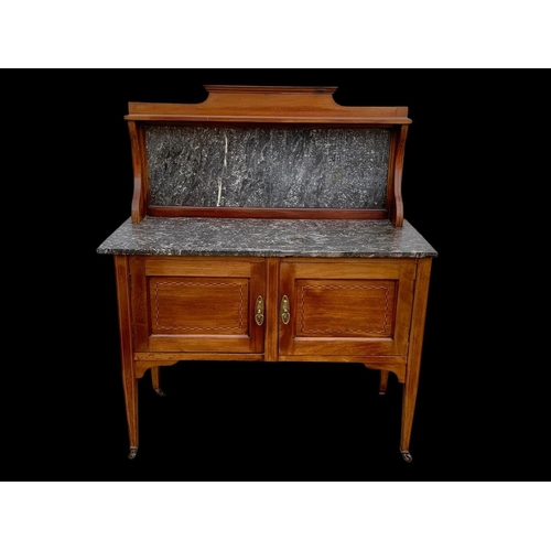 1010 - An Edwardian inlaid mahogany marble top washstand. 106.5 x 45 x 127cm.