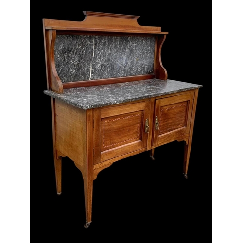 1010 - An Edwardian inlaid mahogany marble top washstand. 106.5 x 45 x 127cm.