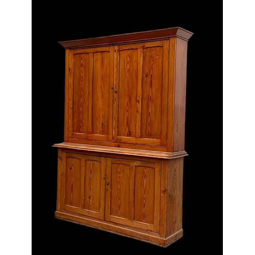 1012 - A large Victorian pitch pine housekeeper's cupboard with fitted shelves. Circa 1880. 164x45x218.5cm