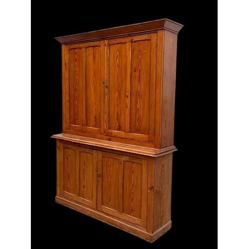 1012 - A large Victorian pitch pine housekeeper's cupboard with fitted shelves. Circa 1880. 164x45x218.5cm