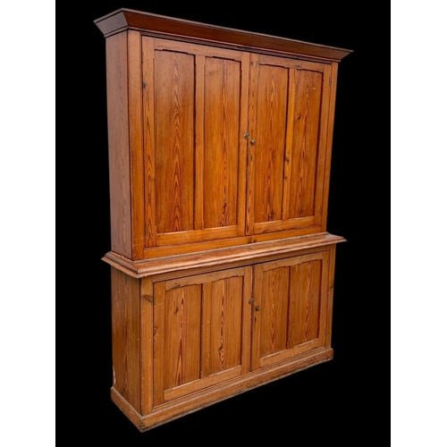 1012 - A large Victorian pitch pine housekeeper's cupboard with fitted shelves. Circa 1880. 164x45x218.5cm