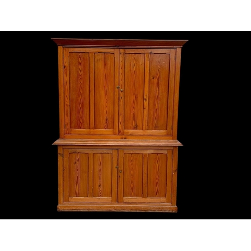 1012 - A large Victorian pitch pine housekeeper's cupboard with fitted shelves. Circa 1880. 164x45x218.5cm