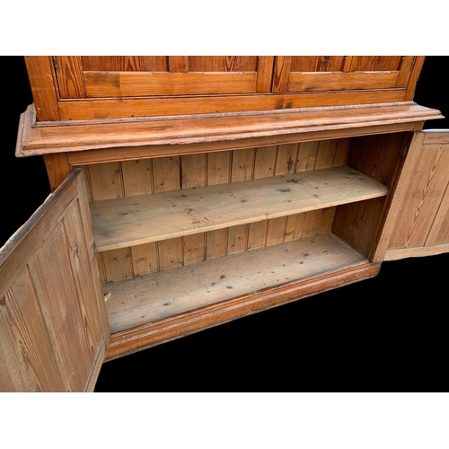 1012 - A large Victorian pitch pine housekeeper's cupboard with fitted shelves. Circa 1880. 164x45x218.5cm