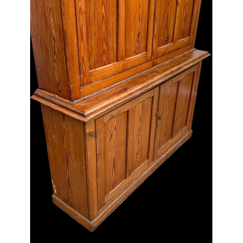 1012 - A large Victorian pitch pine housekeeper's cupboard with fitted shelves. Circa 1880. 164x45x218.5cm