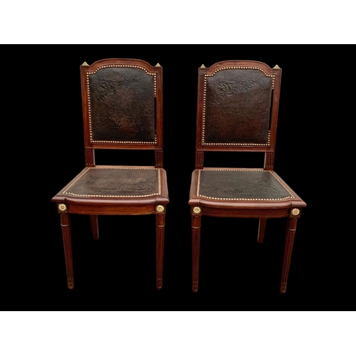 1019 - A pair of 19th century French mahogany side chairs with leather back and seats and brass decoration.... 