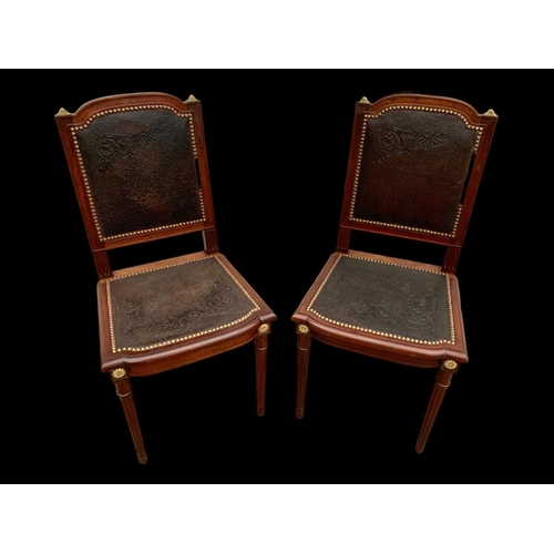 1019 - A pair of 19th century French mahogany side chairs with leather back and seats and brass decoration.... 