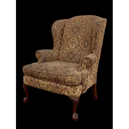 1045 - A large Georgian style wingback armchair. 90 x 73 x 112cm.