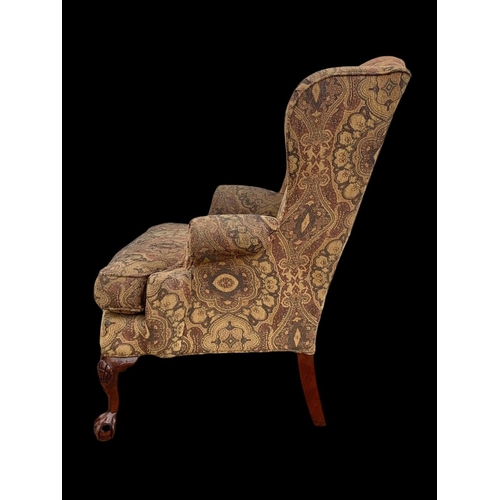 1045 - A large Georgian style wingback armchair. 90 x 73 x 112cm.