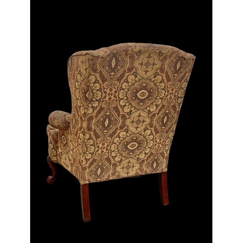 1045 - A large Georgian style wingback armchair. 90 x 73 x 112cm.