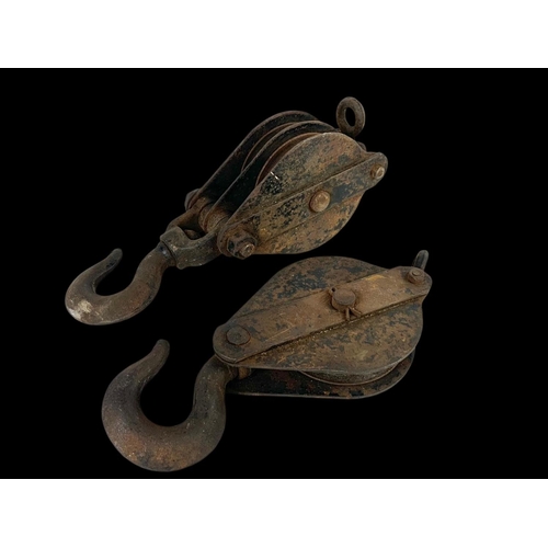 168 - 2 early 20th century metal Pulley’s. Largest 37cm.