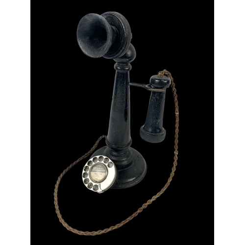 169 - A vintage wooden ornamental candlestick phone. 37cm.