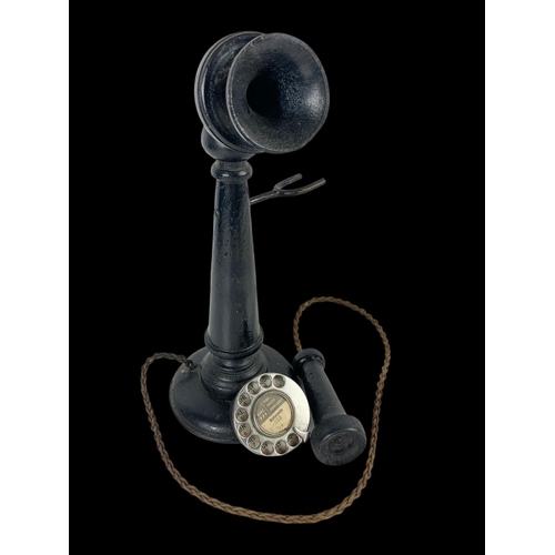 169 - A vintage wooden ornamental candlestick phone. 37cm.