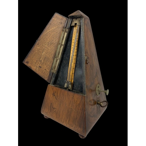 19 - A Victorian rosewood metronome. 23.5cm.