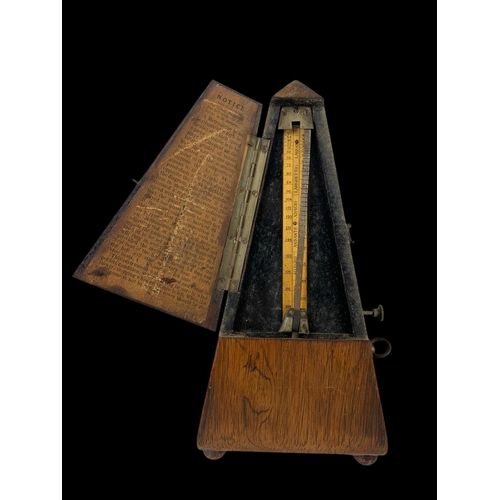 19 - A Victorian rosewood metronome. 23.5cm.