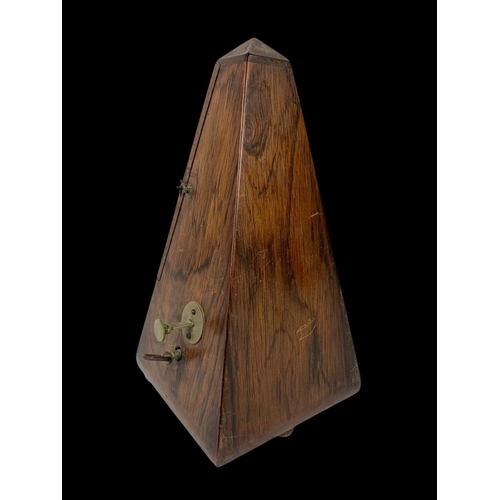 19 - A Victorian rosewood metronome. 23.5cm.