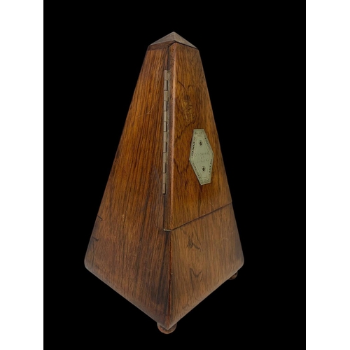 19 - A Victorian rosewood metronome. 23.5cm.