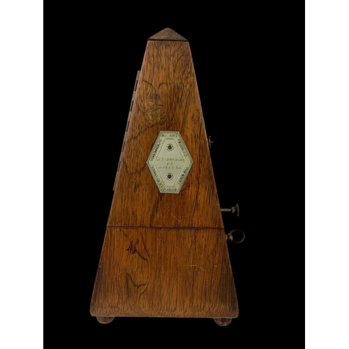 19 - A Victorian rosewood metronome. 23.5cm.