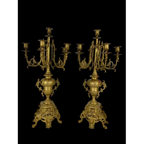 24 - A large vintage ornate brass clock set with candelabras. Clock measures 38 x 13.5 x 33.5cm. Candelab... 