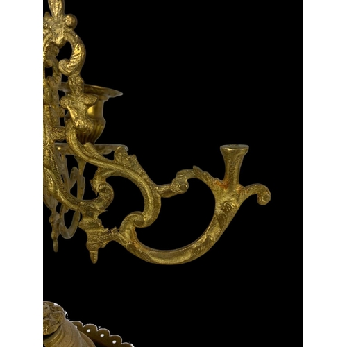 26 - An early 20th century French porcelain and brass clock set. Clock measures 28 x 59cm. Candelabras me... 