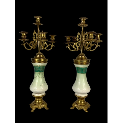 26 - An early 20th century French porcelain and brass clock set. Clock measures 28 x 59cm. Candelabras me... 