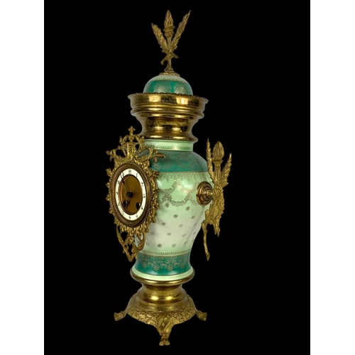 26 - An early 20th century French porcelain and brass clock set. Clock measures 28 x 59cm. Candelabras me... 