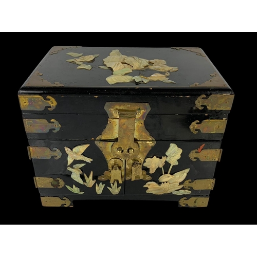 28 - An oriental style brass bound lacquered jewellery box faux ivory. 32 x 21 x 25cm.